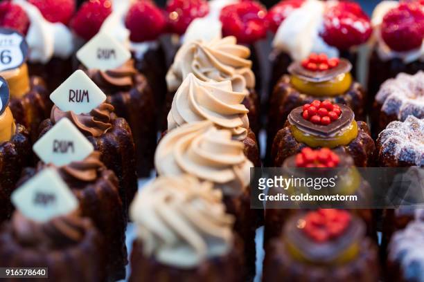 close up of freshly baked cakes and cupcakes in a row at food market - cream cake stock pictures, royalty-free photos & images