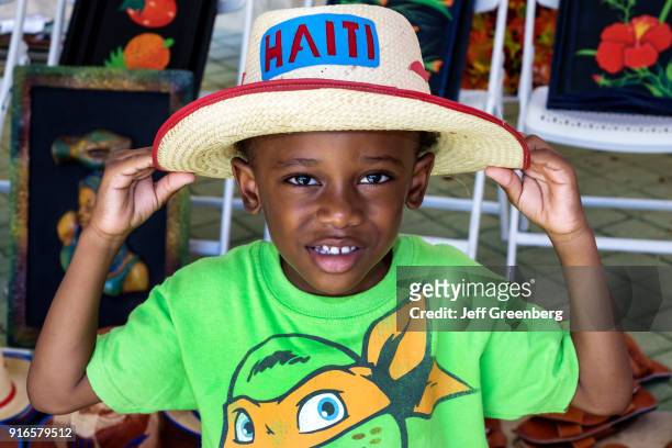 Boy wearing a straw hat at the Haitian-Caribbean Book Fair.