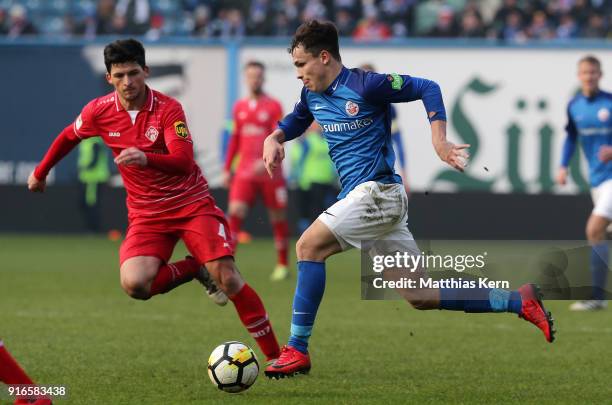 Lukas Scherff of Rostock battles for the ball with Jannis Nikolaou of Wuerzburg during the 3. Liga match between F.C. Hansa Rostock and FC...