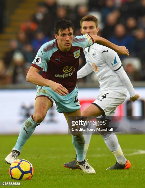 Jack Cork of Burnley is tackled by Tom Carroll of Swansea City during the Premier League match between Swansea City and Burnley at Liberty Stadium on...