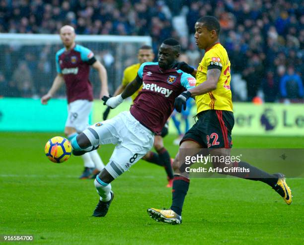 Cheikhou Kouyate of West Ham United in action with Marvin Zeegelaar of Watford during the Premier League match between West Ham United and Watford at...