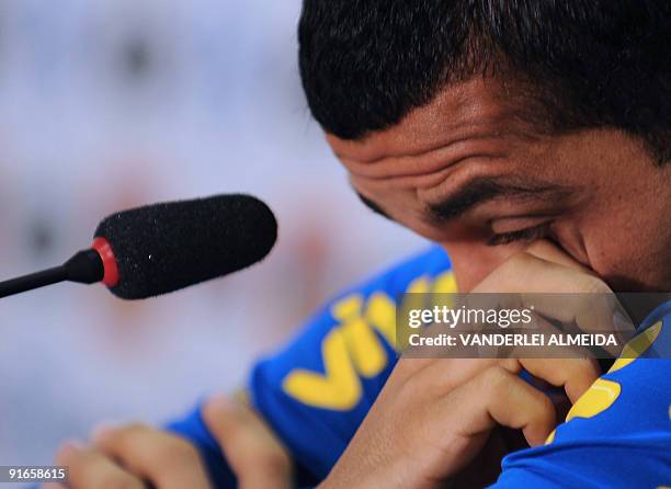 Brazilian national football team player Daniel Alves gestures during a press conference before a training session October 9 in Teresopolis, Brazil....