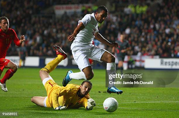 Theo Walcott of England goes round Kristijan Naumovski of Macedonia during the UEFA U21 Championship qualifier between England and Macedonia at the...