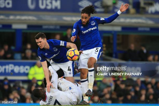 Everton's English defender Michael Keane and Everton's English-born Welsh defender Ashley Williams vie with Crystal Palace's Zaire-born Belgian...