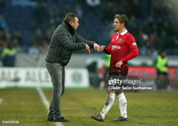 Headcoach Andre Breitenreiter talks to Oliver Sorg of Hannover 96 during the Bundesliga match between Hannover 96 and Sport-Club Freiburg at...