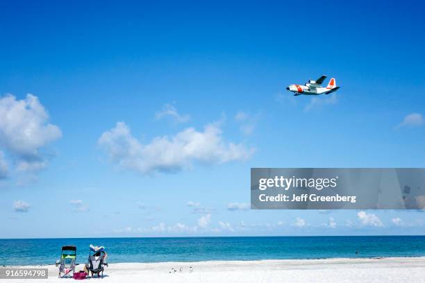 Coast Guard airplane over the beach at Silver Surf Gulf Beach Resort.