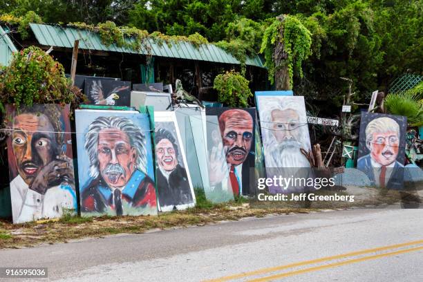 Painted portraits of celebrities on the roadside at New Smyrna Beach.