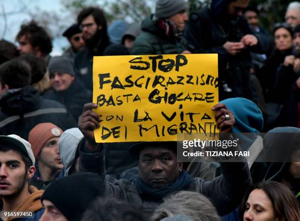 Protester holds a placard reading "stop to the fascism and racism, stop playing with the migrants' life" during an anti-racism demonstration one week...