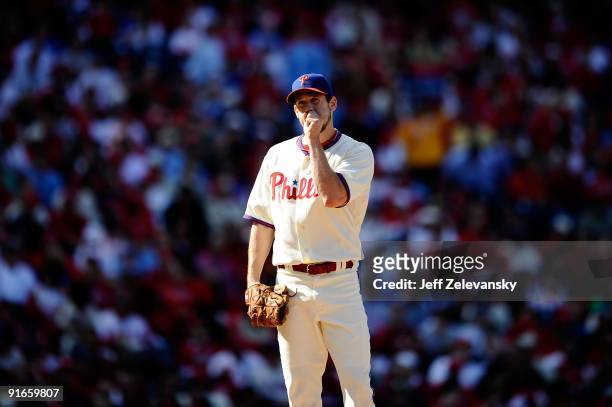 Starting pitcher Cliff Lee of the Philadelphia Phillies gets set to throw a pitch against the Colorado Rockies in Game One of the NLDS during the...
