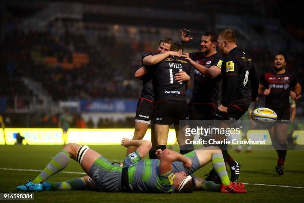 Max Malins of Saracens celebrates his try with team mates during the Aviva Premiership match between Saracens and Newcastle Falcons at Allianz Park...