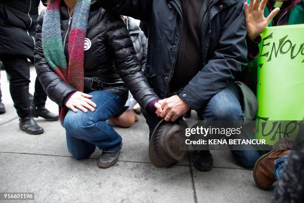 Immigrant rights activist Ravi Ragbir and his wife Amy Gottlieb pray in front of the immigration building as they attend a Rally a day after he...