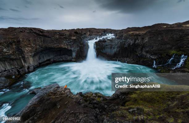 one man photographing aldeyjafoss waterfall, iceland - majestic waterfall stock pictures, royalty-free photos & images