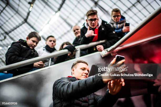Goalkeeper Bernd Leno of Leverkusen takes a selfie with young fans prior to the Bundesliga match between Bayer 04 Leverkusen and Hertha BSC at...
