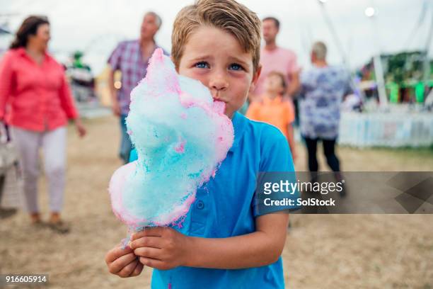 he loves eating cotton candy - cotton candy stock pictures, royalty-free photos & images