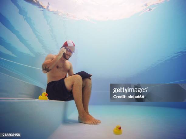 man working at the telephone underwater - crazy pool stock pictures, royalty-free photos & images