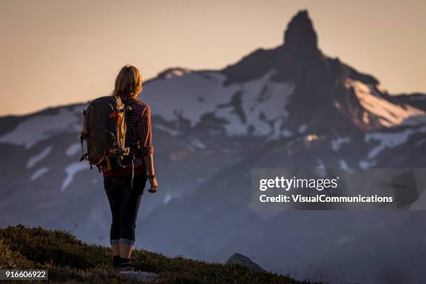 young woman hiking in whistler backcountry. - canadian wilderness stock pictures, royalty-free photos & images