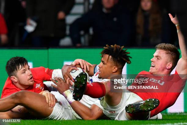 Wales' Gareth Anscombe raises his arm as he slides with England's wing Anthony Watson claiming a try that the TMO ruled out during the Six Nations...