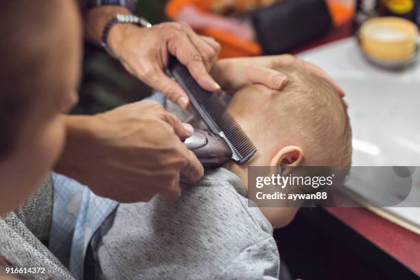 baby boy getting his first haircut - mother combing sons hair stock pictures, royalty-free photos & images