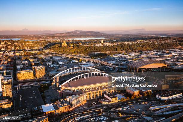 aerial view of stadium and seattle at sunset, usa - seattle aerial stock pictures, royalty-free photos & images