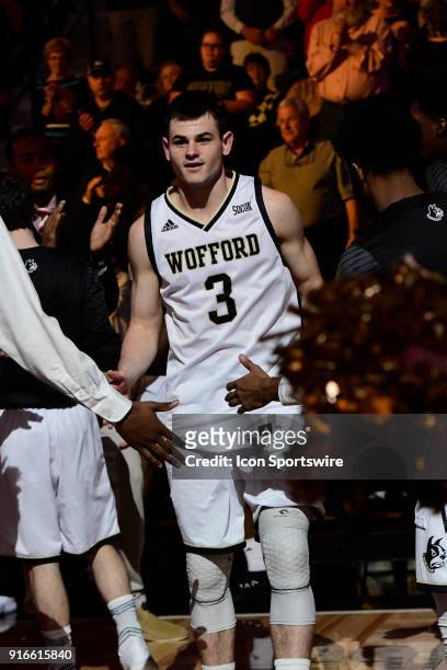 Fletcher Magee guard Wofford College Terriers runs through a gauntlet during player introductions before the Southern Conference game against the...
