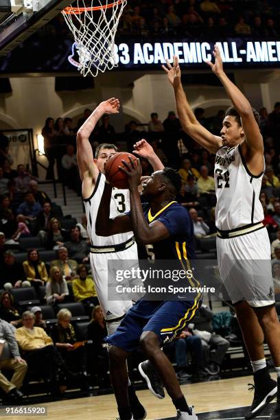 Peter Jurkin center East Tennessee State University Buccaneers draws the attention of Fletcher Magee guard and Keve Aluma forward Wofford College...