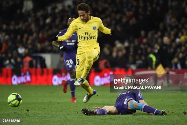 Toulouse's French midfielder Yannick Cahuzac tackles Paris Saint-Germain's Brazilian forward Neymar Jr during the French L1 football match between...