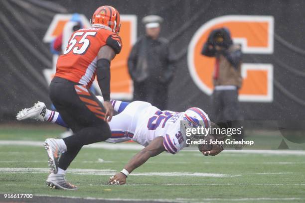 Mike Tolbert of the Buffalo Bills runs the football up field against Vontaze Burfict of the Cincinnati Bengals during their game at Paul Brown...