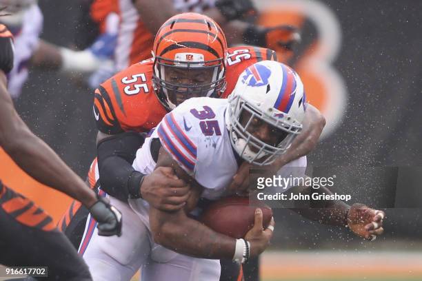 Mike Tolbert of the Buffalo Bills runs the football up field against Vontaze Burfict of the Cincinnati Bengals during their game at Paul Brown...