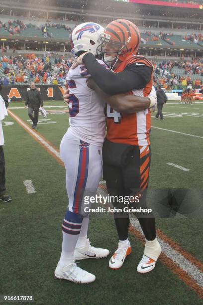 Jerry Hughes of the Buffalo Bills shares a moment at midfield with Andy Dalton of the Cincinnati Bengals during their game at Paul Brown Stadium on...