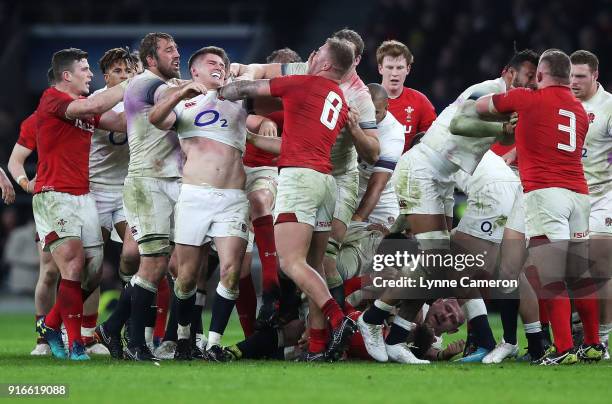 Owen Farrell of England and Ross Moriarty of Wales scuffle during the NatWest Six Nations match between England and Wales at Twickenham Stadium on...