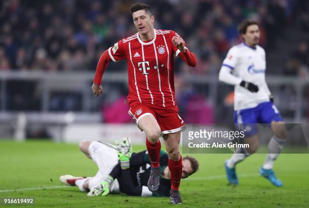 Robert Lewandowski of Bayern Muenchen scores a goal past goalkeeper Ralf Faehrmann of Schalke to make it 1:0 during the Bundesliga match between FC...