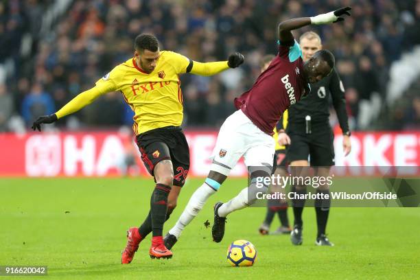 Etienne Capoue of Watford pushes Cheikhou Kouyate of West Ham as they battle for the ball during the Premier League match between West Ham United and...