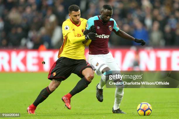 Etienne Capoue of Watford and Cheikhou Kouyate of West Ham battle for the ball during the Premier League match between West Ham United and Watford at...