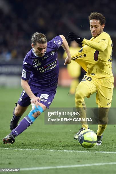 Toulouse's French midfielder Yannick Cahuzac outruns Paris Saint-Germain's Brazilian forward Neymar Jr during the French L1 football match between...