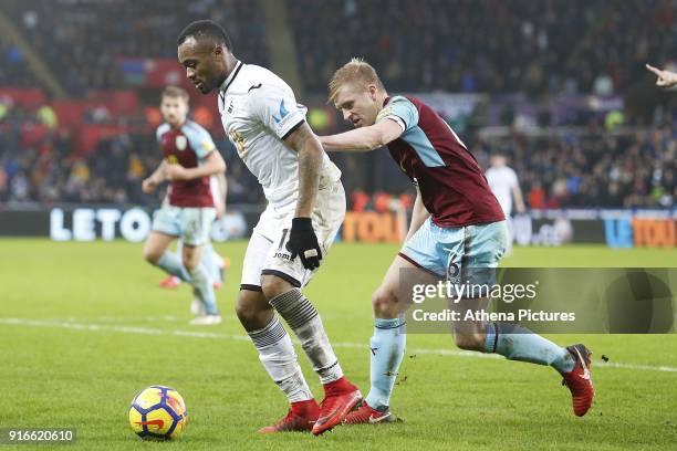 Jordan Ayew of Swansea City is marked by Ben Mee of Burnley during the Premier League match between Swansea City and Burnley at the Liberty Stadium...