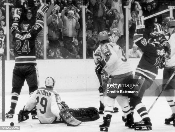 Robert McClanahan raises his arms after scoring the third and deciding goal for the American Olympic hockey team against Finland's goalie Jorma...