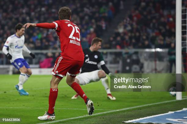 Thomas Mueller of Bayern Muenchen scores a goal past goalkeeper Ralf Faehrmann of Schalke to make it 2:1 during the Bundesliga match between FC...
