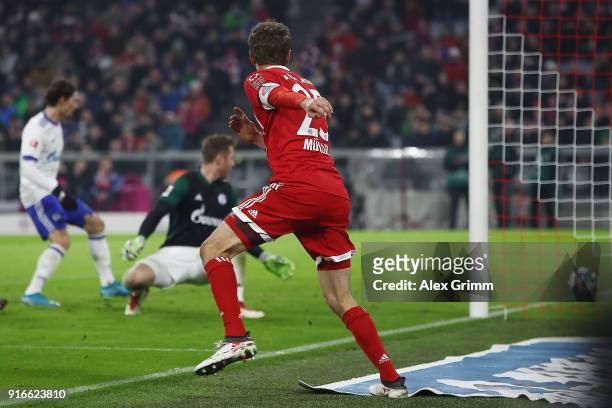 Thomas Mueller of Bayern Muenchen scores a goal past goalkeeper Ralf Faehrmann of Schalke to make it 2:1 during the Bundesliga match between FC...