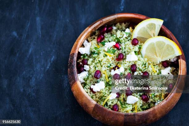 delicious healthy cous cous salad with herbs, lemon zest, feta cheese and pomegranate seeds - tabbouleh stock pictures, royalty-free photos & images