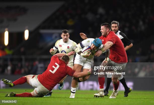 Jack Nowell of England is tackled by Samson Lee of Wales and Rob Evans of Wales during the NatWest Six Nations round two match between England and...