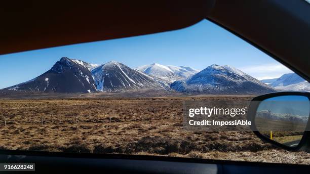 landscape snowcapped mountain roadside view looking through car window, iceland - impossiable fotografías e imágenes de stock