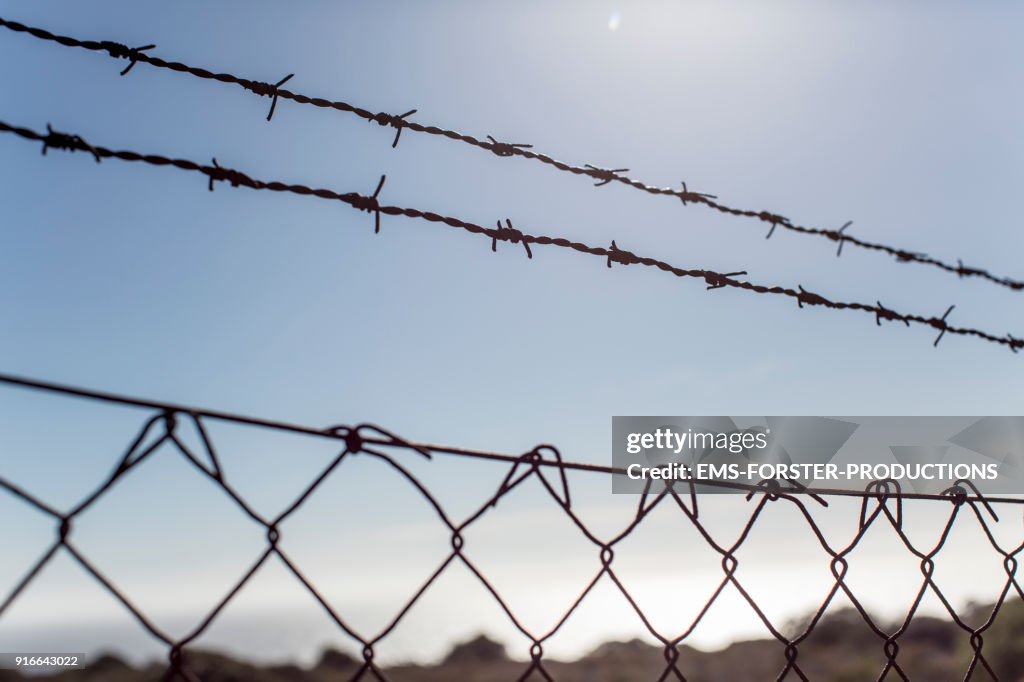 Barbed wire fence on street