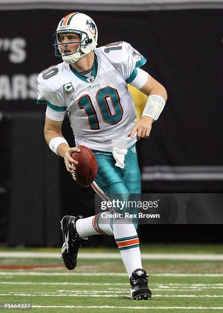 Chad Pennington of the Miami Dolphins rolls out looking to pass against the Atlanta Falcons at Georgia Dome on September 13, 2008 in Atlanta,...