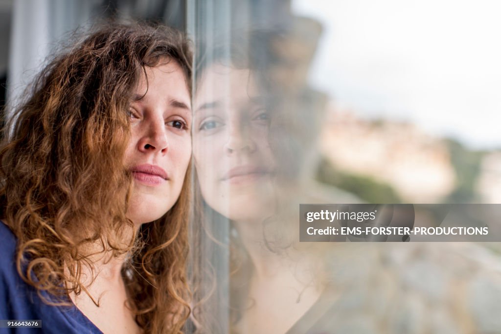 Sad woman looking out of the window