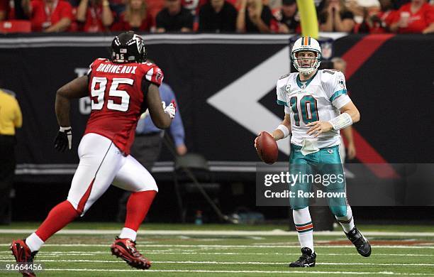 Chad Pennington of the Miami Dolphins rolls out looking to pass against the Atlanta Falcons at Georgia Dome on September 13, 2008 in Atlanta,...