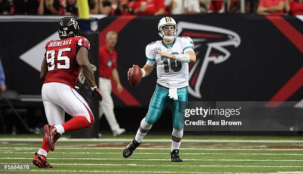 Chad Pennington of the Miami Dolphins rolls out looking to pass against the Atlanta Falcons at Georgia Dome on September 13, 2008 in Atlanta,...