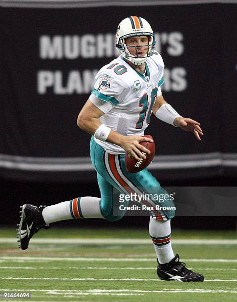 Chad Pennington of the Miami Dolphins rolls out looking to pass against the Atlanta Falcons at Georgia Dome on September 13, 2008 in Atlanta,...