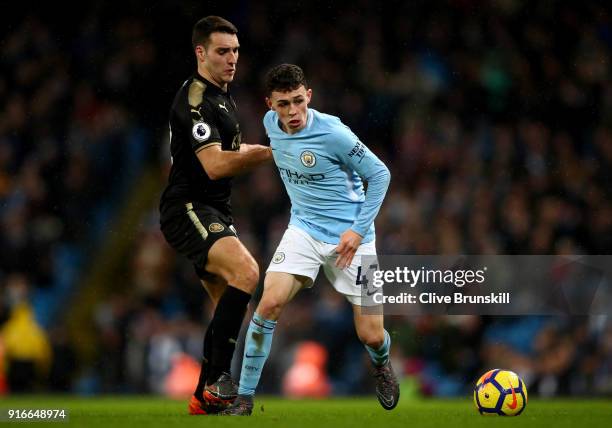 Matty James of Leicester City and Phil Foden of Manchester City battle for the ball during the Premier League match between Manchester City and...