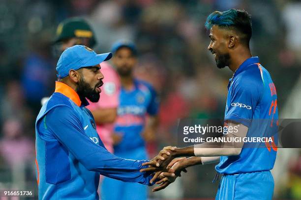 Indian Captain Virat Kohli and Indian bowler Hardik Pandya celebrate the dismissal of South African batsman AB de Villiers during the fourth One Day...