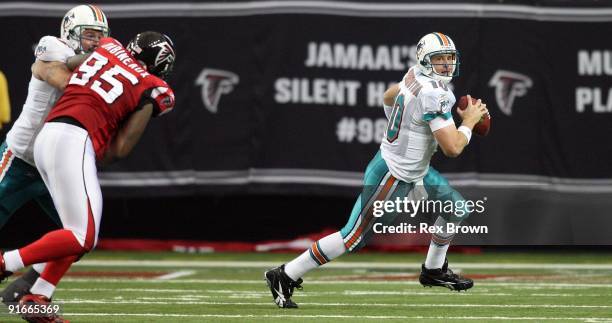 Chad Pennington of the Miami Dolphins rolls out looking to pass against the Atlanta Falcons at Georgia Dome on September 13, 2008 in Atlanta,...